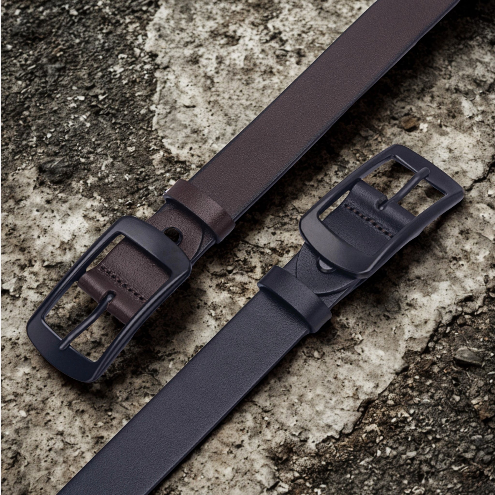 28mm Black and Brown Leather Belt with Black Buckle on a concrete benchtop - BeltUp Leather Co.