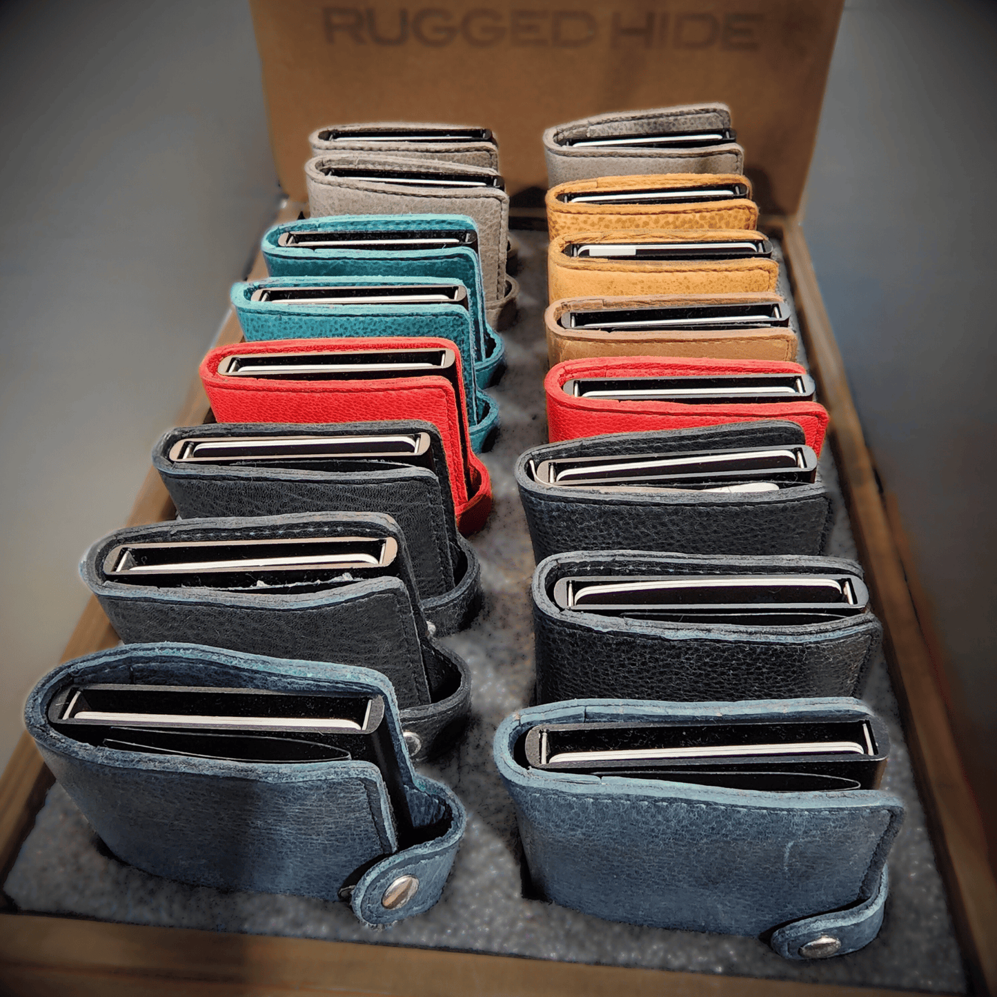 large display box of multiple colour options for the pop up credit card wallet